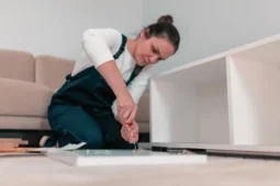 Familia sentada en la mesa del comedor reparando ropa y pequeños electrodomésticos, en una muestra clara de economía circular doméstica.